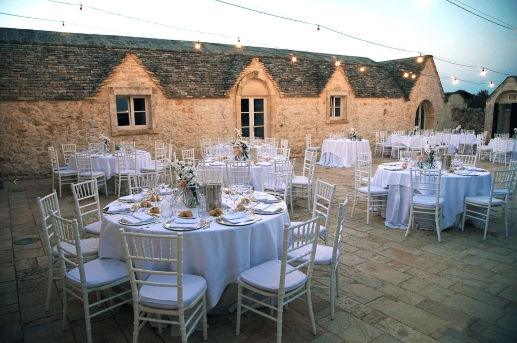 Foto de la corte de la masseria con banquete de boda. Elopement